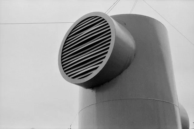 Technician inspecting air ducts
